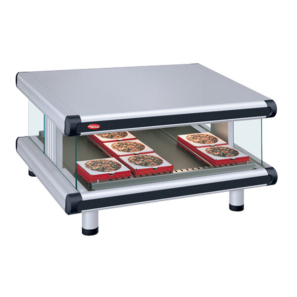 A white Hatco countertop food warmer with pizza on a slanted shelf.