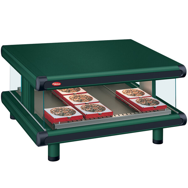 A green Hatco countertop warmer with shelves of pizza.
