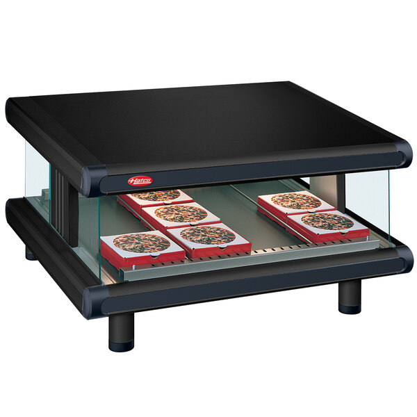A black rectangular Hatco countertop display case with pizza on a shelf.