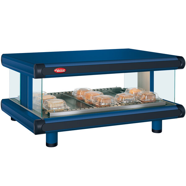 A navy blue Hatco food warmer with trays of food on a counter.