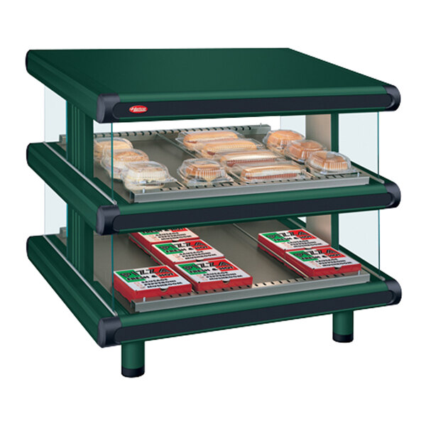 A Hunter Green Hatco countertop display case with food on slanted shelves.