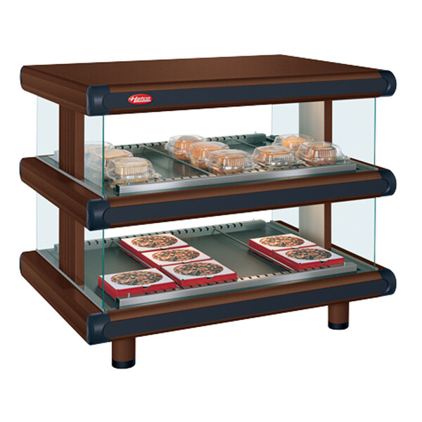 A Hatco countertop display case with trays of food in it.
