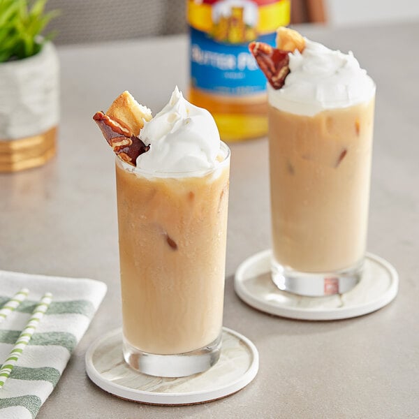 A glass of iced coffee with Torani Butter Pecan flavoring syrup and whipped cream.