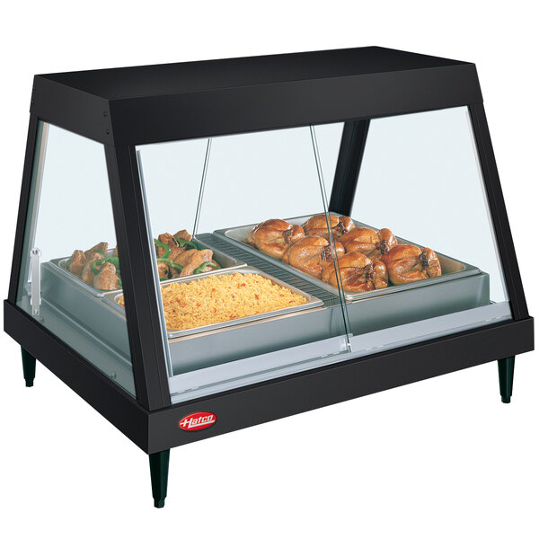 A Hatco countertop food display warmer with food on a tray inside.