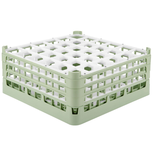 A light green plastic Vollrath glass rack with white squares.