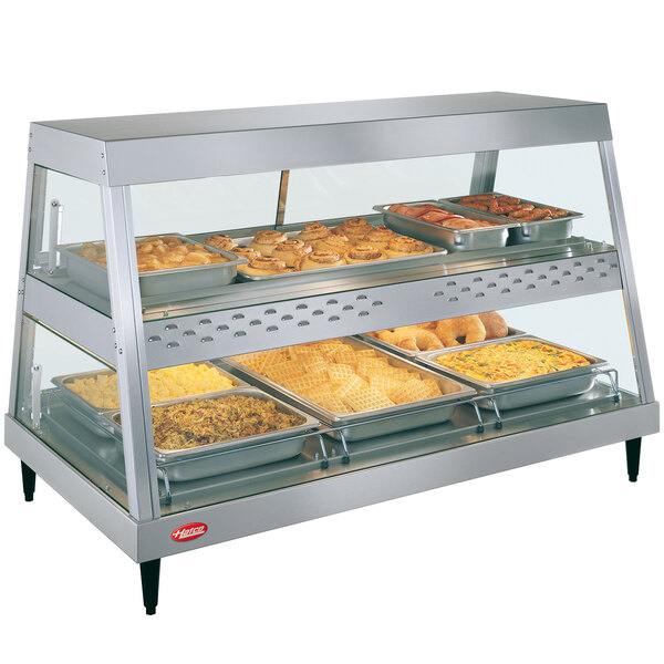 A Hatco stainless steel countertop display case with food on shelves.