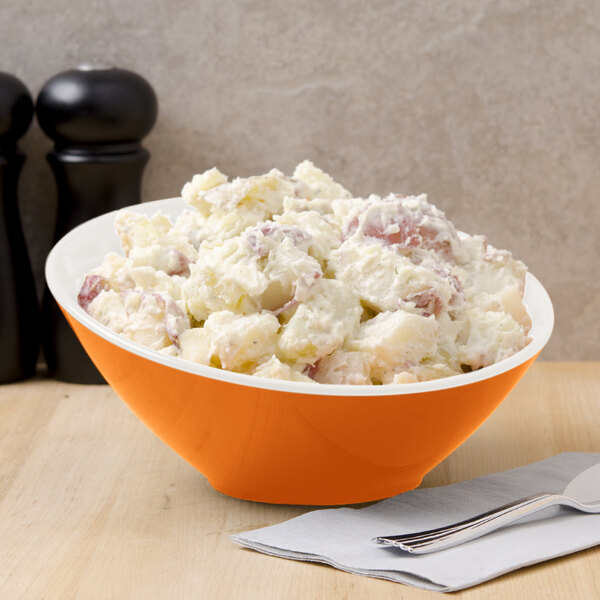 A bowl of potato salad in a GET Sunset melamine bowl with a fork.