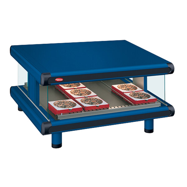 A blue Hatco countertop with pizza in boxes on a slanted shelf.