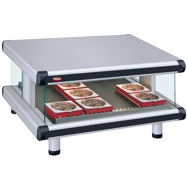 A Hatco countertop food warmer with trays of pizza.