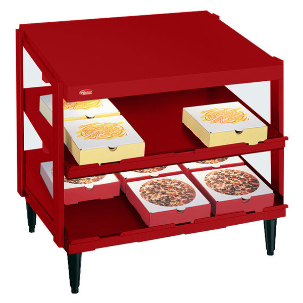A red Hatco Glo-Ray pizza warmer with pizza boxes on the shelves.