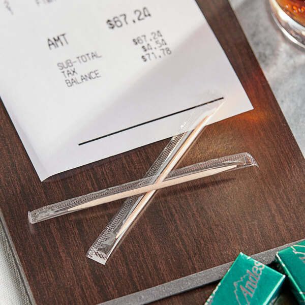 A receipt on a table with Royal Paper toothpicks.