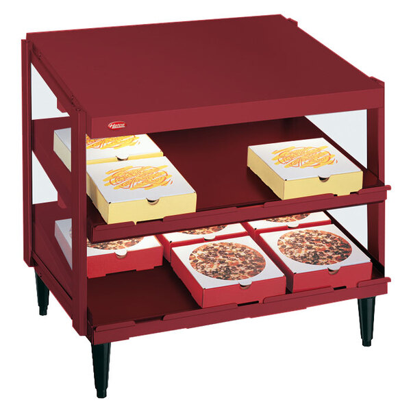 A red Hatco pizza warmer shelf with pizza boxes inside.