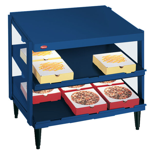 A blue Hatco display case with pizza boxes on shelves.