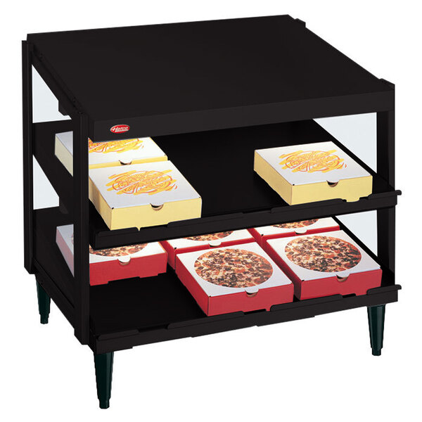 A black Hatco countertop display case with pizza boxes on it.