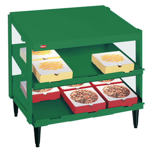 A Hatco Hunter Green pizza warmer shelf with pizza boxes on it.