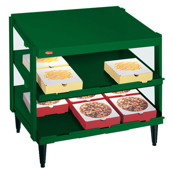 A Hatco Hunter Green Glo-Ray double shelf with pizza boxes on it.