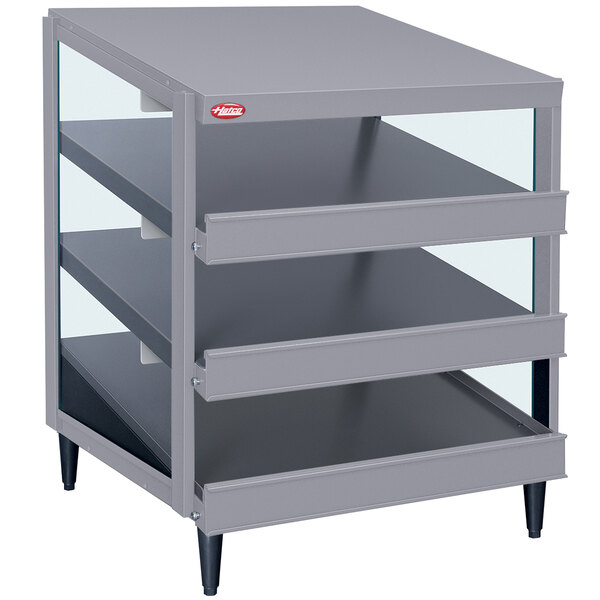 A gray metal shelf with three shelves on a table in a bakery display.