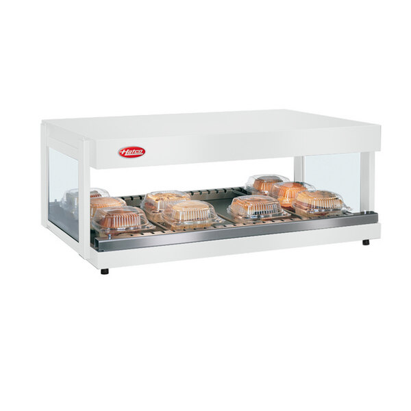 A white Hatco countertop food warmer with a tray of food on top.
