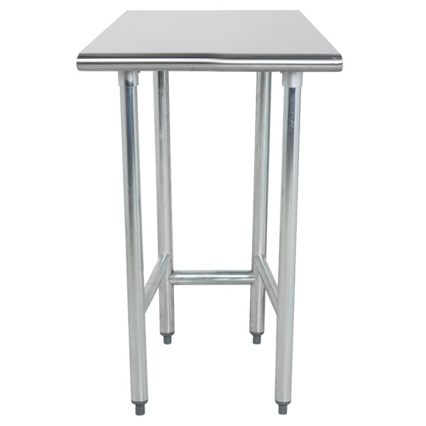 A close-up of an Advance Tabco stainless steel work table with an open base.
