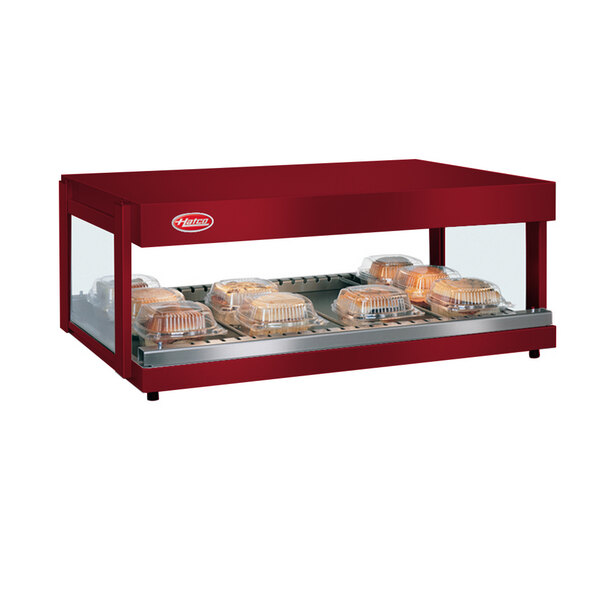 A red Hatco countertop food warmer with a tray of food.