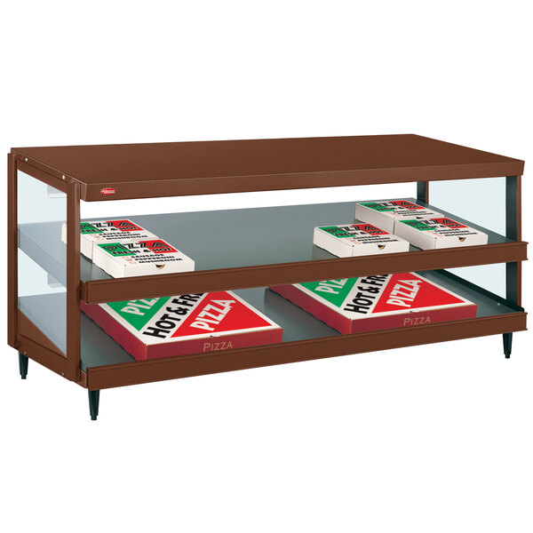 A Hatco countertop display shelf with pizza boxes on it.