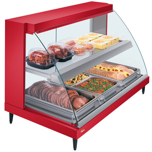 A red Hatco countertop food warmer with glass shelves and a glass door displaying food.