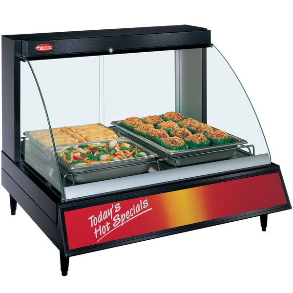 A Hatco countertop food display warmer with food on a tray inside.