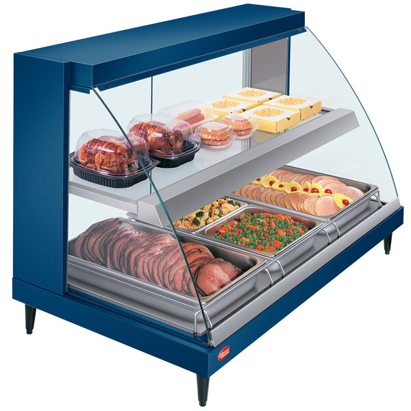 A blue Hatco countertop food warmer display case with food on it.