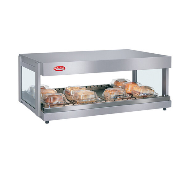 A Hatco Granite Glo-Ray food warmer with trays of food on a shelf.
