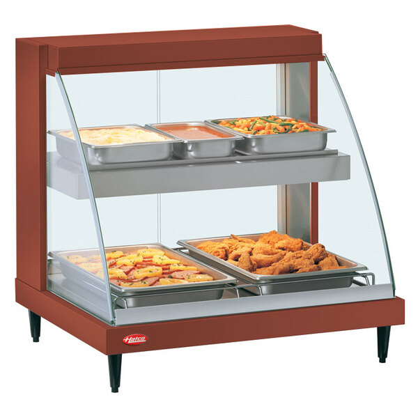 A Hatco copper countertop food warmer with trays and pans holding food.