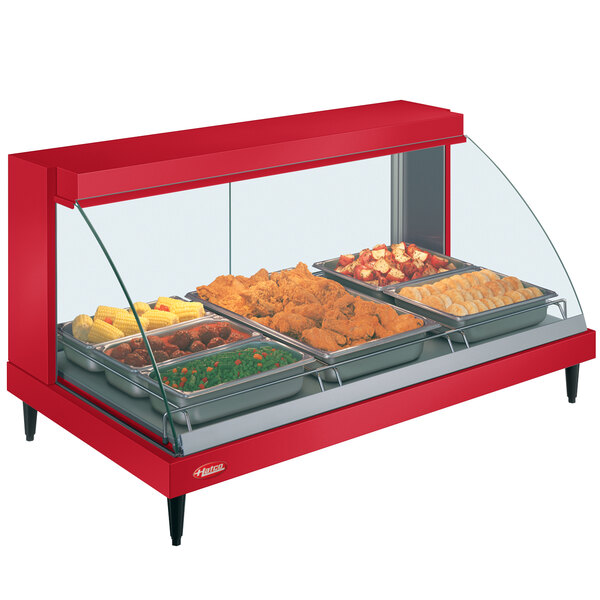 A red Hatco countertop food warmer display case with trays of food.