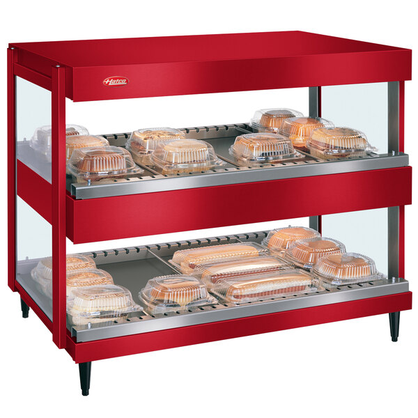 A red Hatco food warmer with trays of food on display.