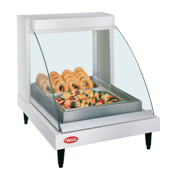 A Hatco countertop display case with food on a tray inside.