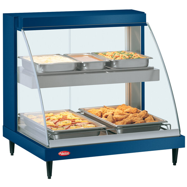 A blue Hatco countertop hot food display warmer with shelves holding pans of food.