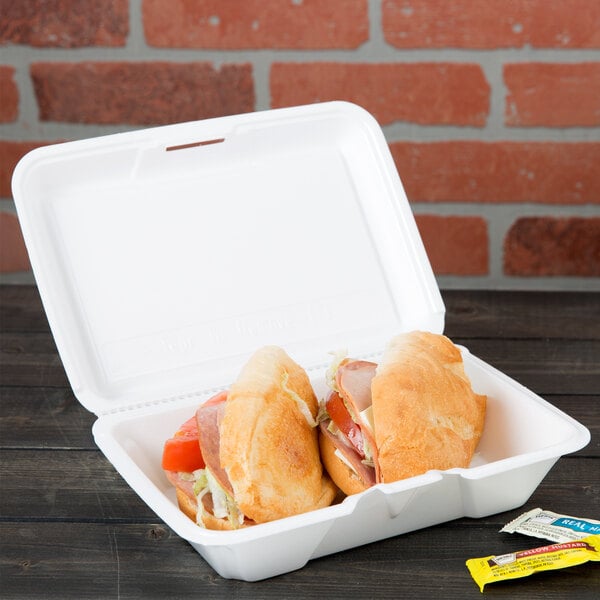 A sandwich in a Dart white foam takeout container.