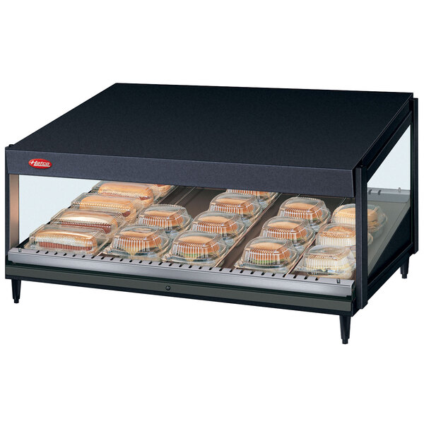 A black Hatco countertop display case with trays of food.