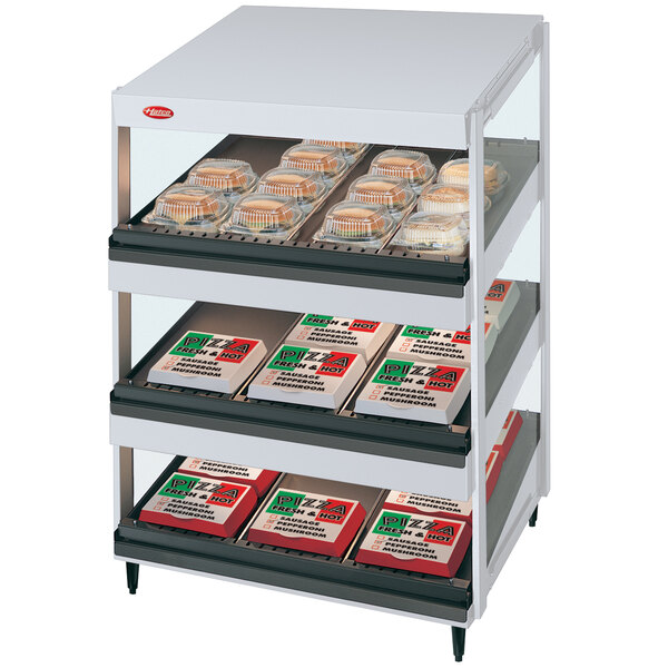 A white Hatco countertop display shelf with food trays.