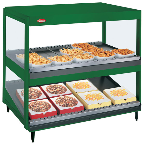 A Hatco Hunter Green countertop display with shelves holding food trays.