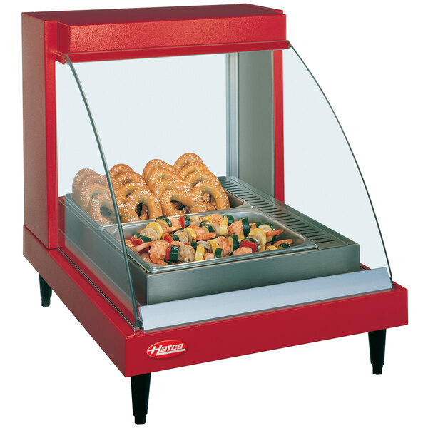 A red Hatco countertop food warmer with a tray of food.