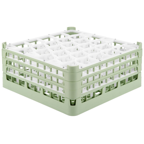 A light green Vollrath glass rack with 30 compartments.