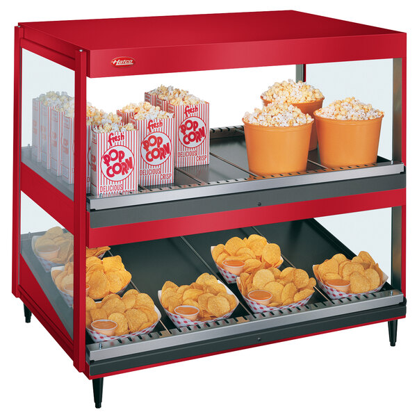 A red Hatco countertop display case with popcorn and chips.