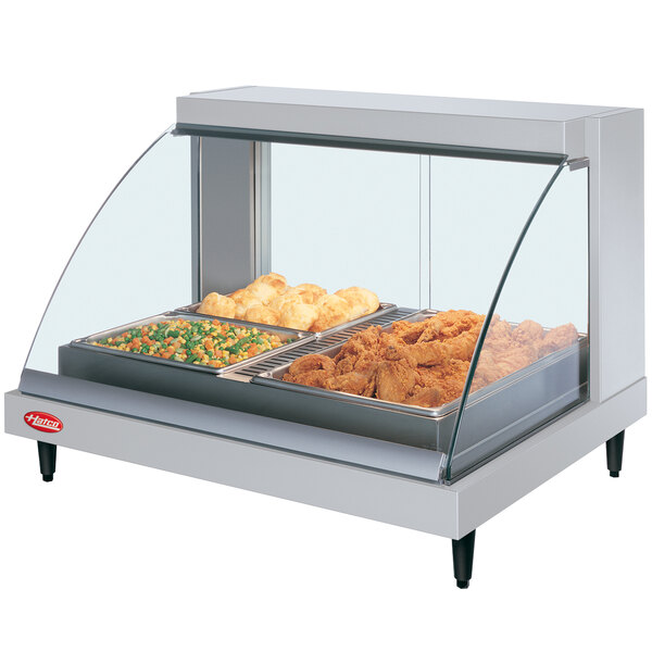 A Hatco countertop food warmer with food trays of vegetables in a display case.