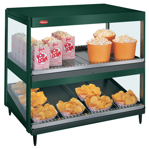 A large Hatco countertop display case filled with popcorn and potato chips.