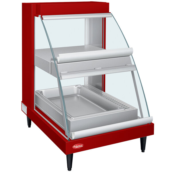 A red Hatco countertop display case with two glass shelves.