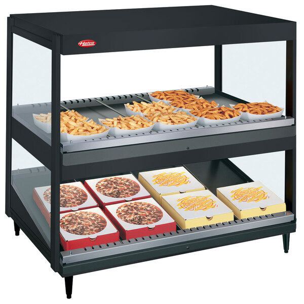 A black Hatco countertop display with food trays holding french fries.