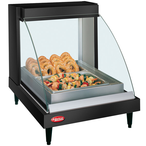 A black Hatco countertop food warmer with a shelf of food inside.