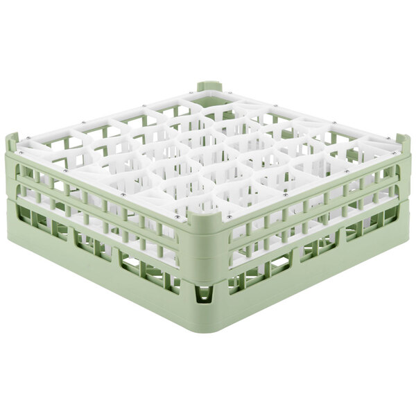 A Vollrath light green glass rack with white handles.