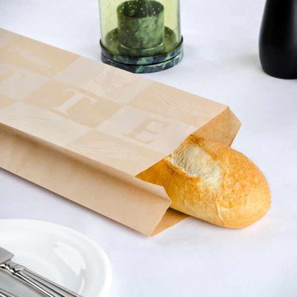 A loaf of bread in a Bagcraft Packaging paper bag on a table.
