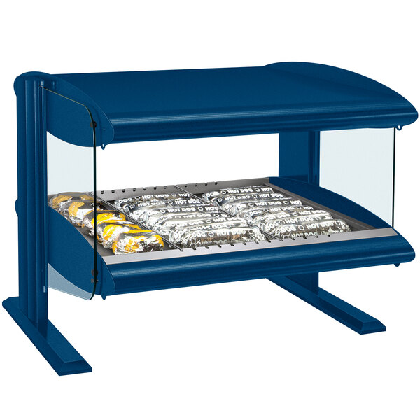 A blue Hatco countertop display shelf with food in it.