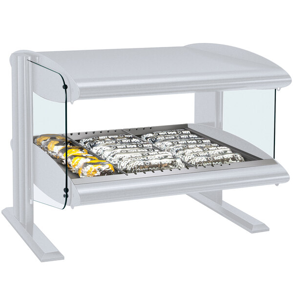 A white Hatco countertop display shelf with food in a glass case.